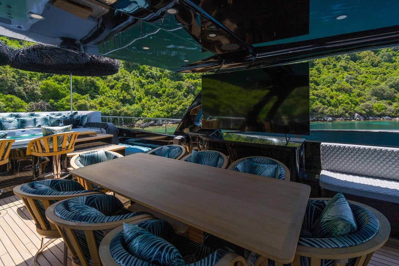 a patio with a table and chairs aboard QUEEN KARINA Yacht for Sale