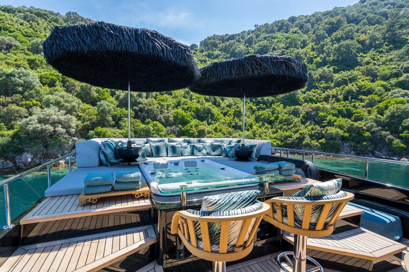 a pool with a table and chairs aboard QUEEN KARINA Yacht for Sale