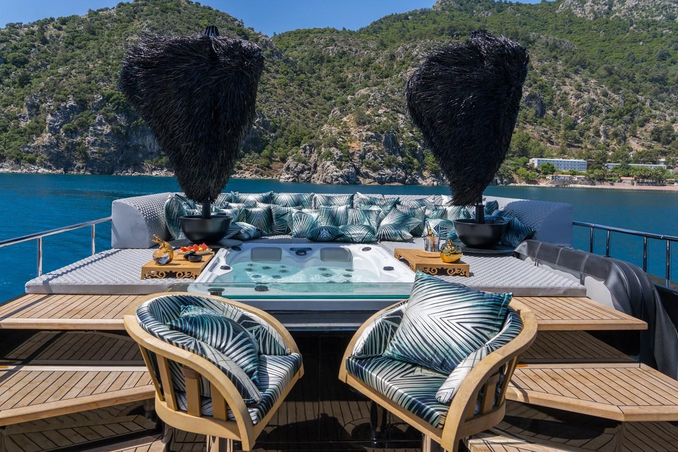 a table with a large black object on it and a large rock in the background aboard QUEEN KARINA Yacht for Sale