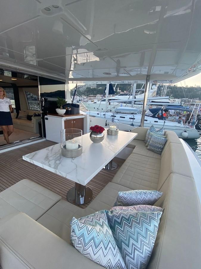 a boat with a table and chairs aboard FREE MIND Yacht for Sale