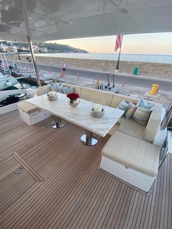 a room with a table and chairs on it aboard FREE MIND Yacht for Sale