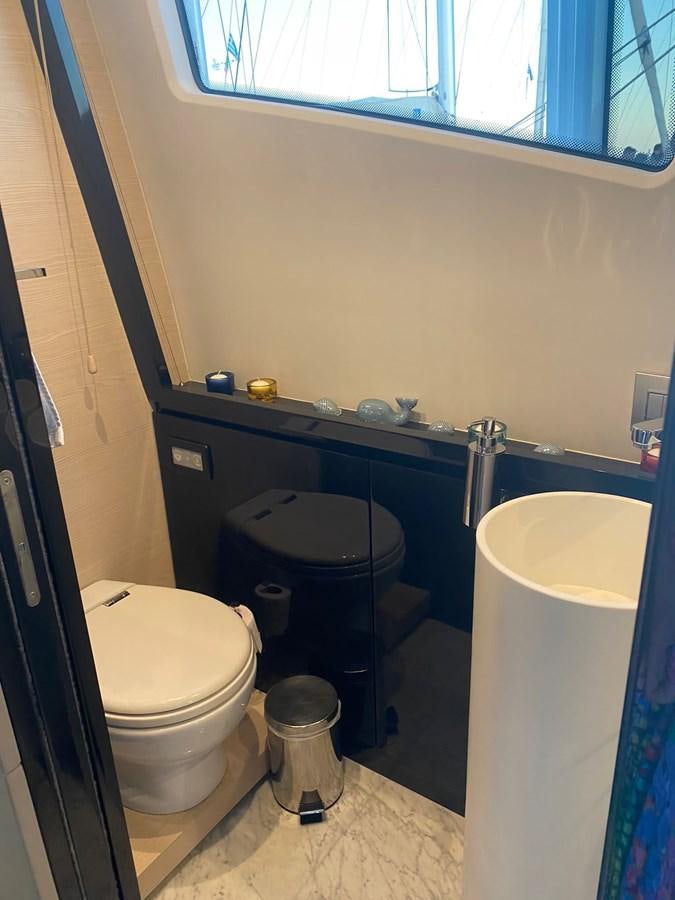 a bathroom with a tub toilet and sink aboard FREE MIND Yacht for Sale