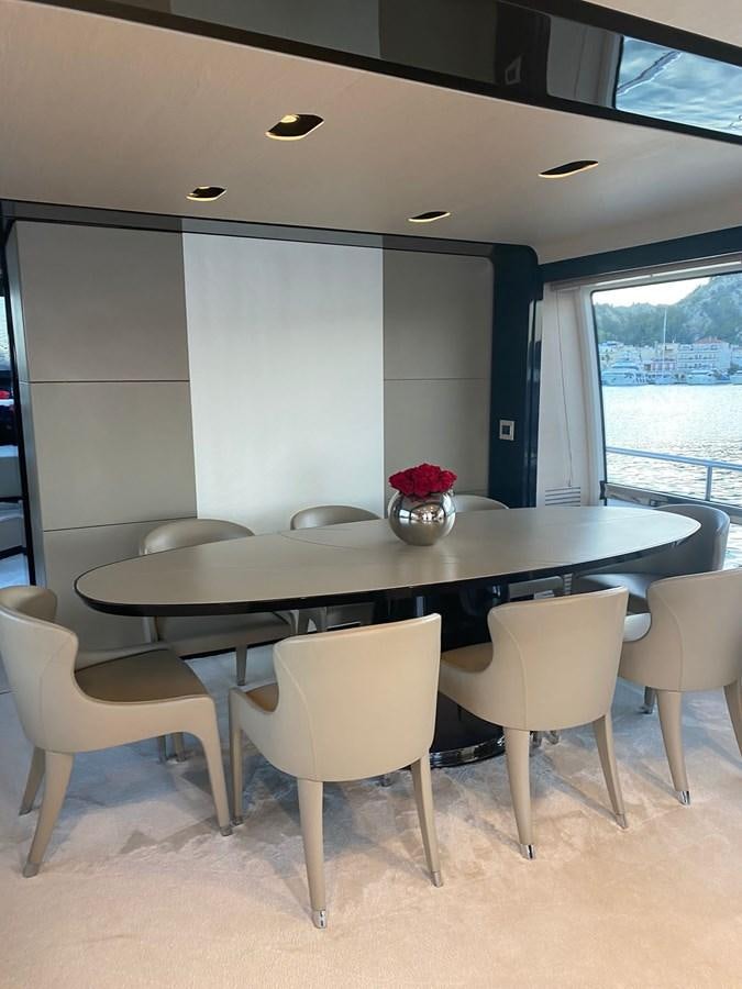 a table with chairs around it aboard FREE MIND Yacht for Sale