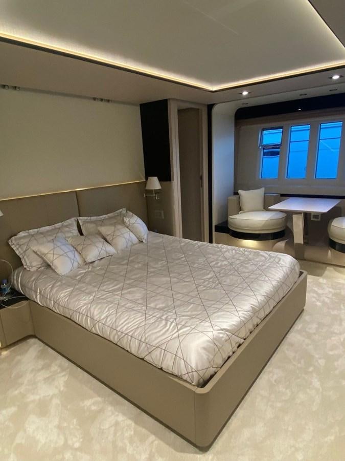 a bed with a white comforter aboard FREE MIND Yacht for Sale