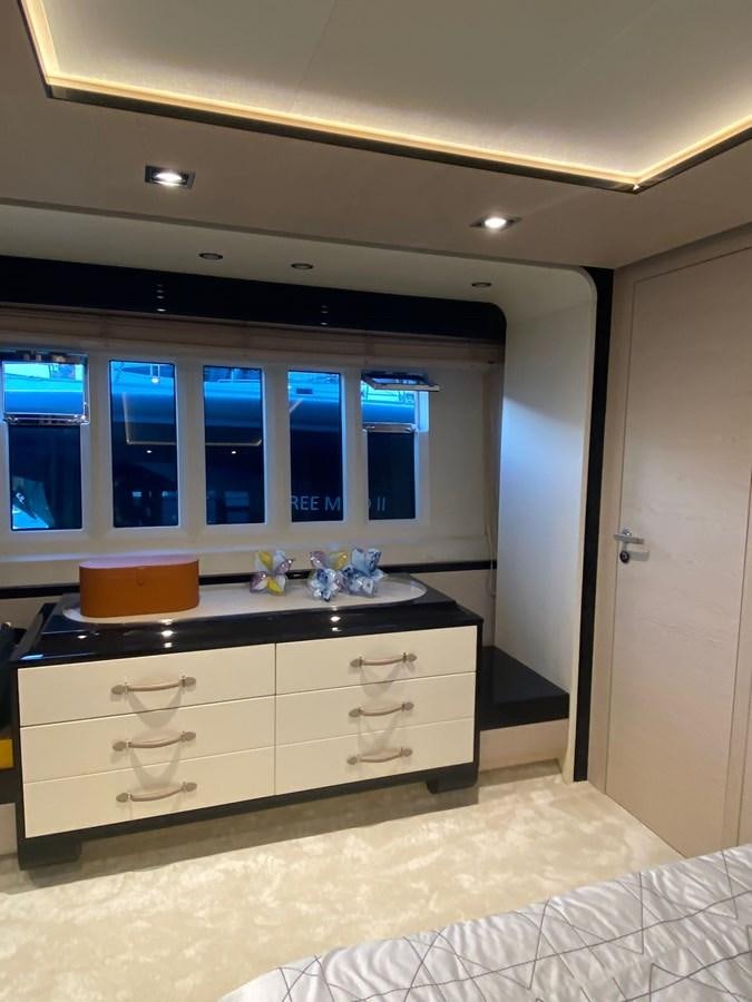 a white kitchen with a black counter aboard FREE MIND Yacht for Sale