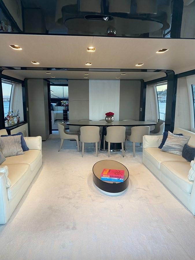 a living room with a table and couches aboard FREE MIND Yacht for Sale