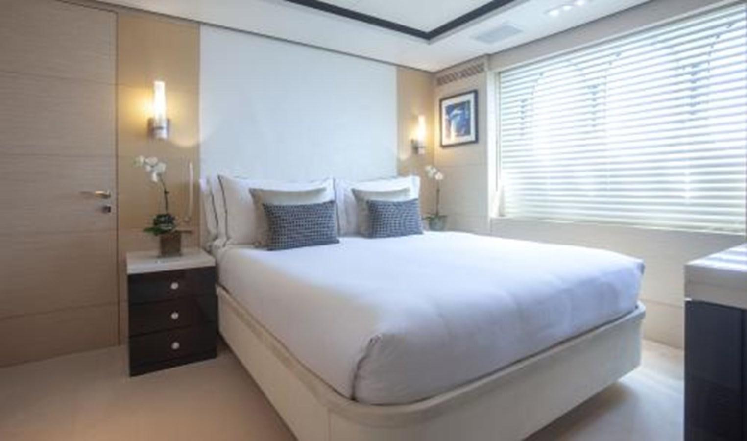 a bedroom with a bed and a dresser aboard SUR LA MER Yacht for Sale