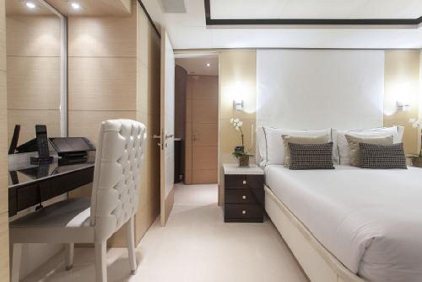 a room with a bed and a desk aboard SUR LA MER Yacht for Sale
