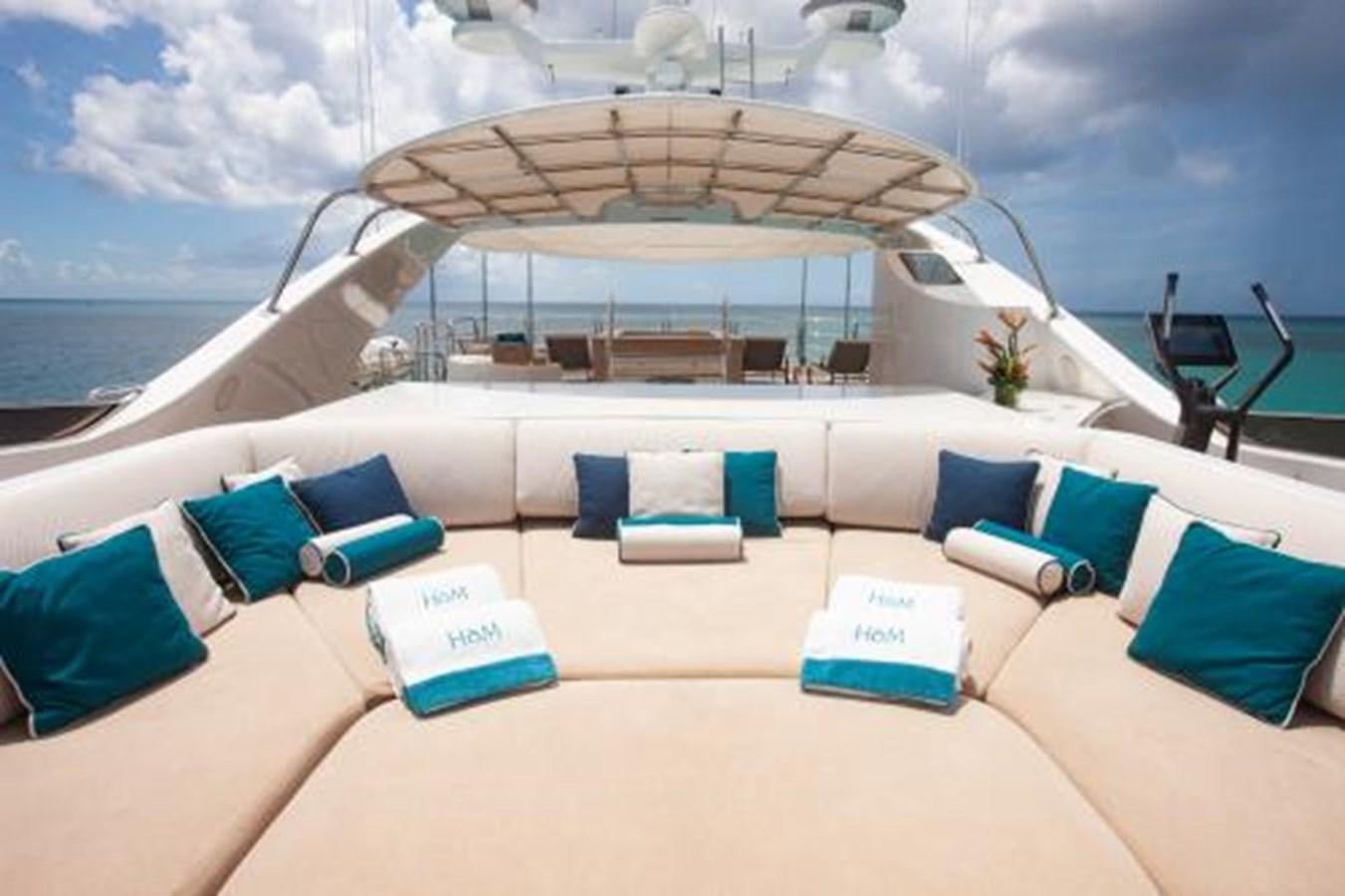 a large white and blue lounge area on a beach with a large umbrella aboard SUR LA MER Yacht for Sale