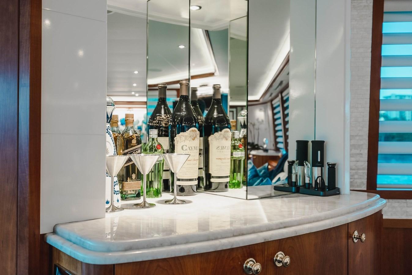 a counter with bottles and glasses aboard LA LADY Yacht for Sale