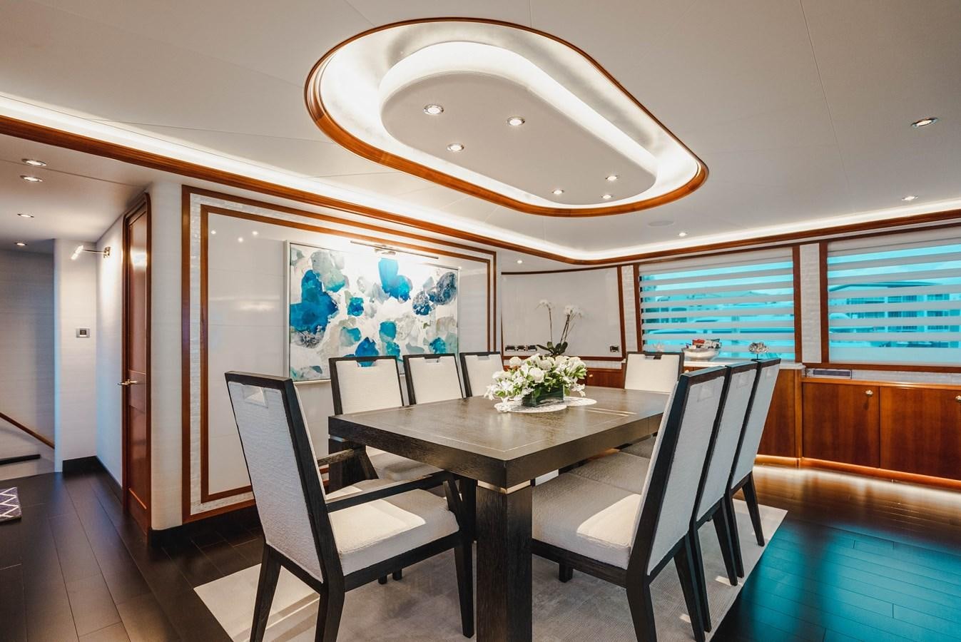 a room with a table and chairs aboard LA LADY Yacht for Sale