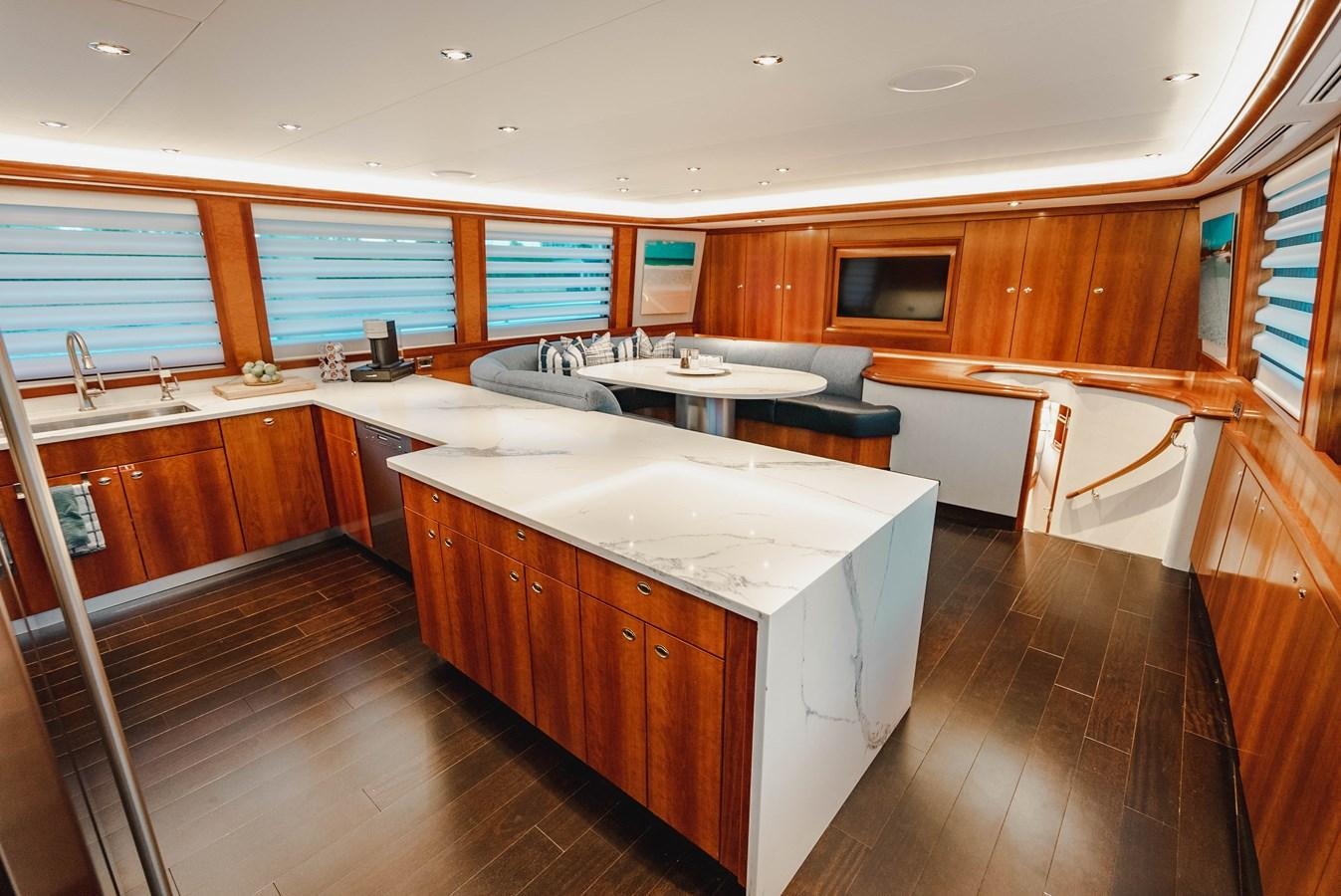 a large kitchen with wooden cabinets aboard LA LADY Yacht for Sale