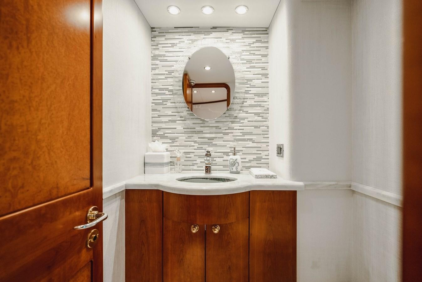 a bathroom with a sink and a mirror aboard LA LADY Yacht for Sale