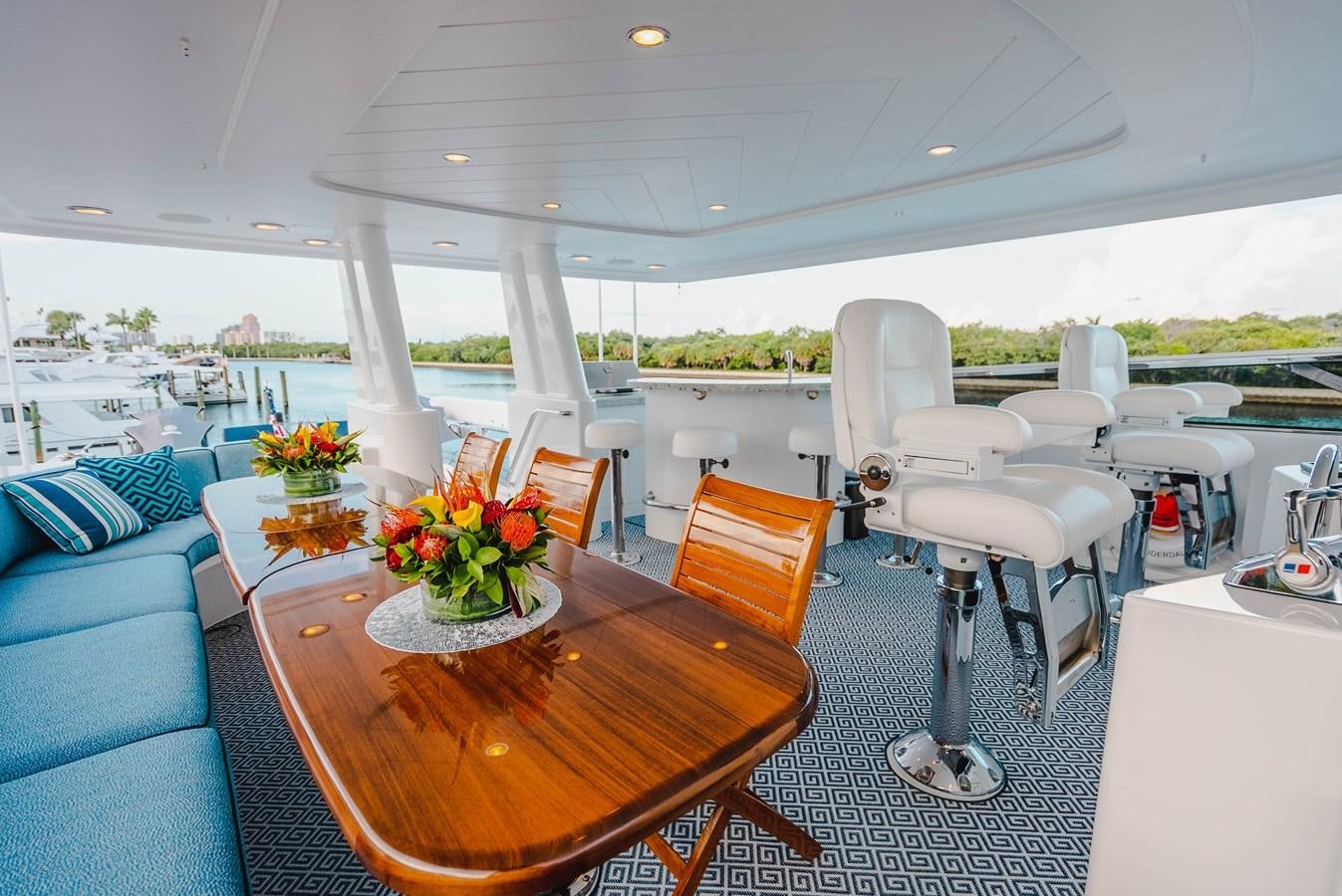 a room with a table and chairs aboard LA LADY Yacht for Sale