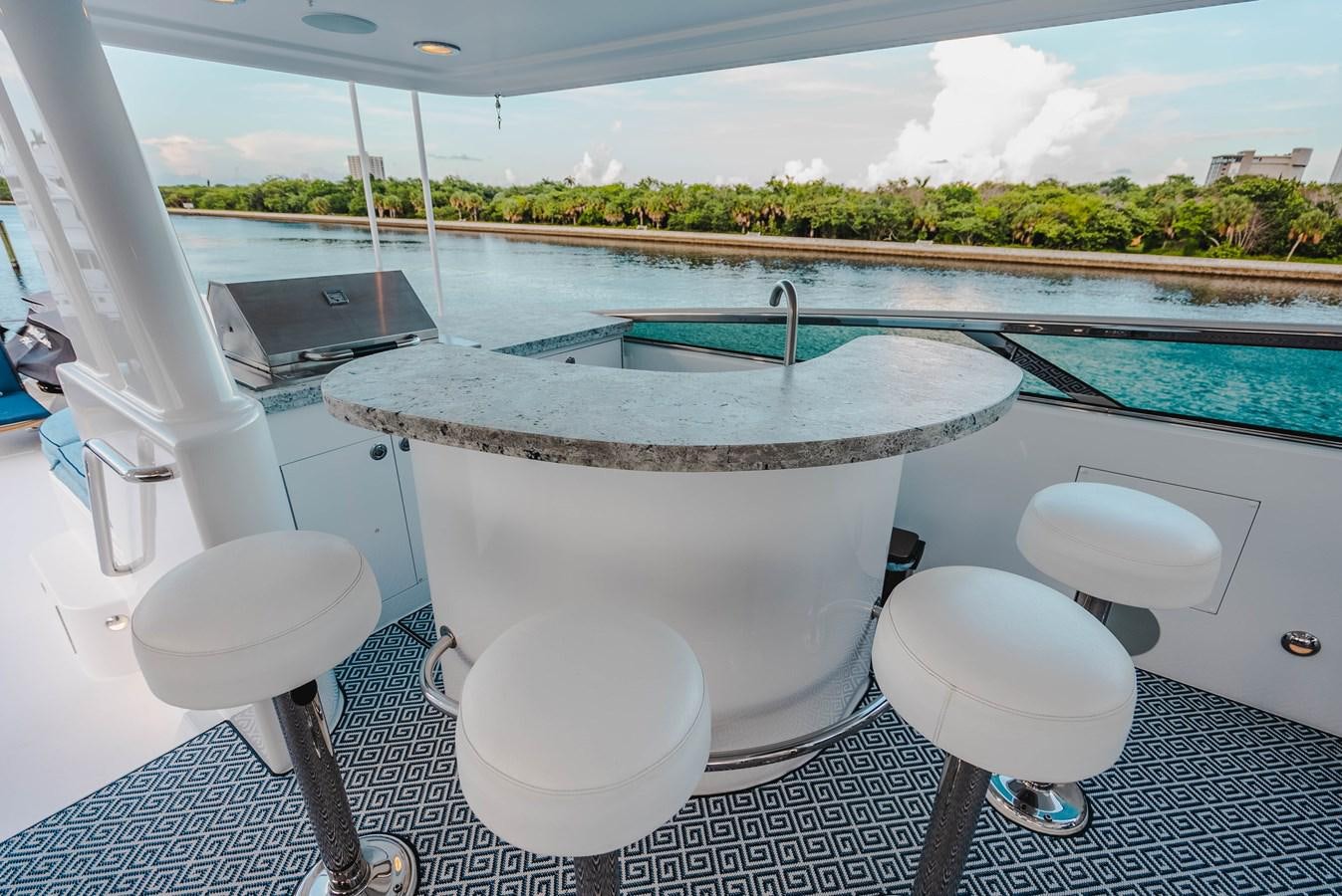 a white tub and stools by a pool aboard LA LADY Yacht for Sale
