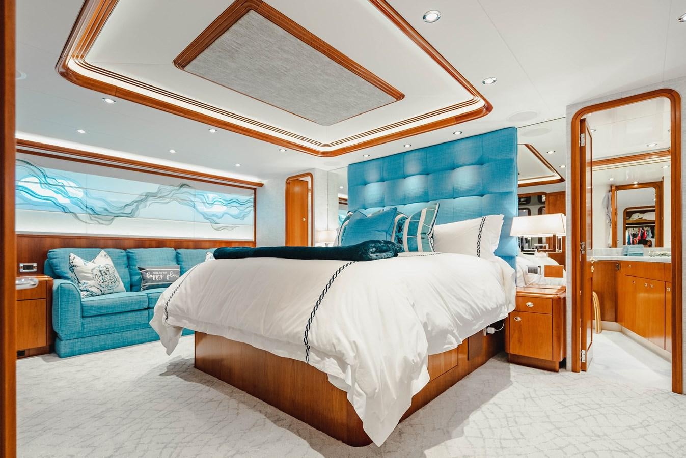 a bedroom with a bed and a couch aboard LA LADY Yacht for Sale