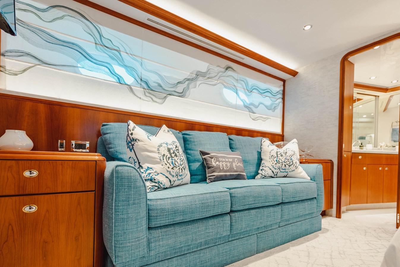 a blue couch in a bedroom aboard LA LADY Yacht for Sale