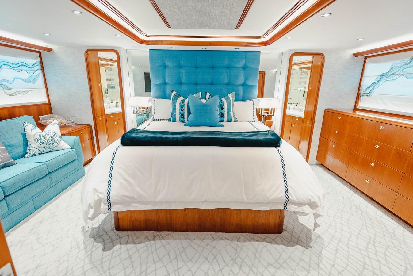 a bed with a blue sheet aboard LA LADY Yacht for Sale