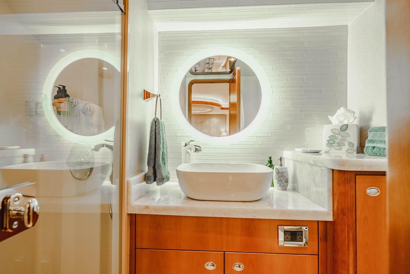 a bathroom with a sink and a mirror aboard LA LADY Yacht for Sale