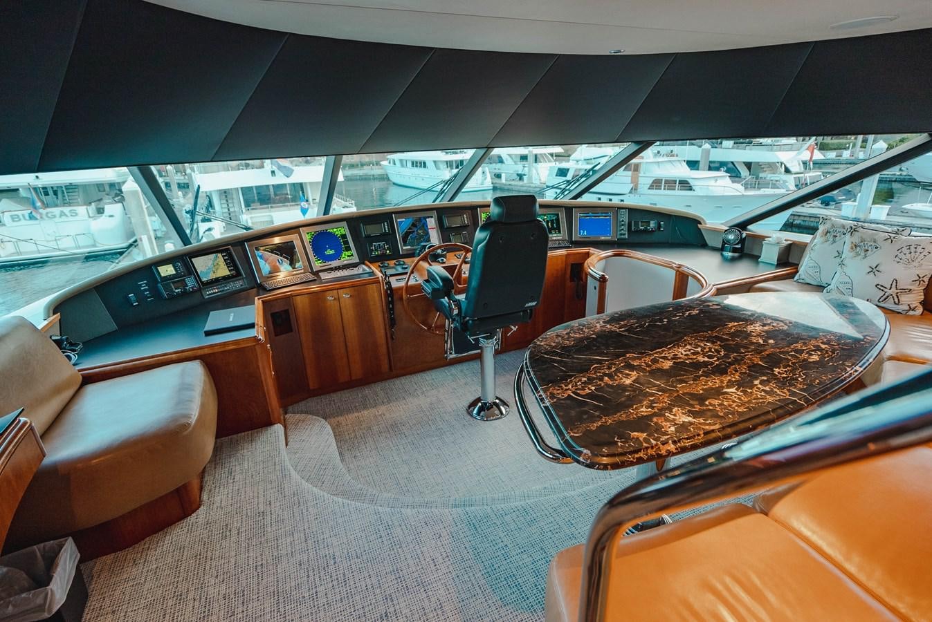 a room with a large table and chairs with a large pizza in it aboard LA LADY Yacht for Sale
