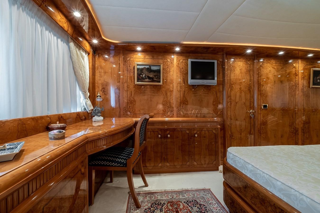 a room with a bed and a desk aboard LADY ADELHEID Yacht for Sale