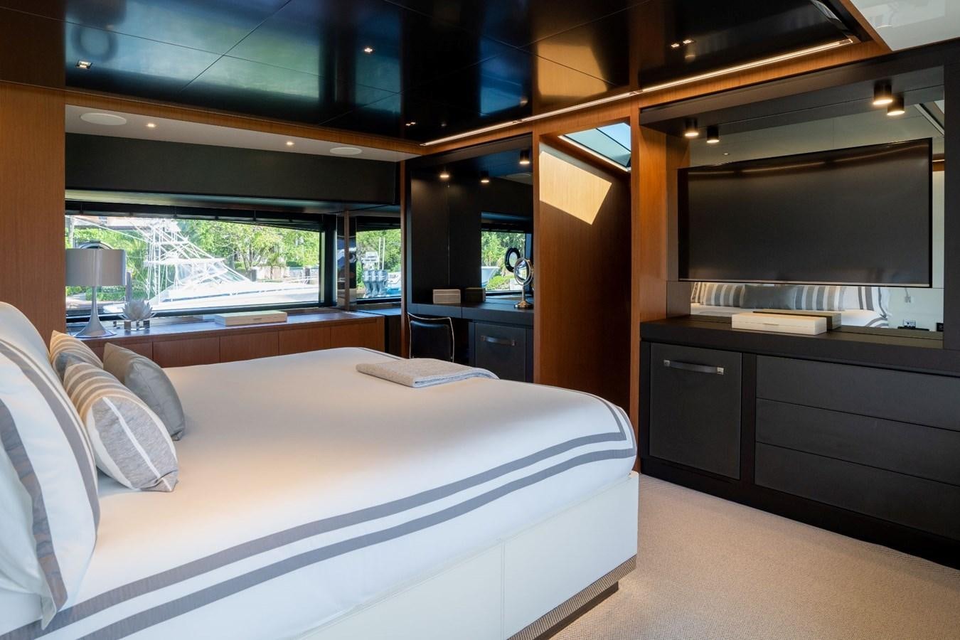 a room with a bed and a desk aboard BEYOND BEYOND Yacht for Sale