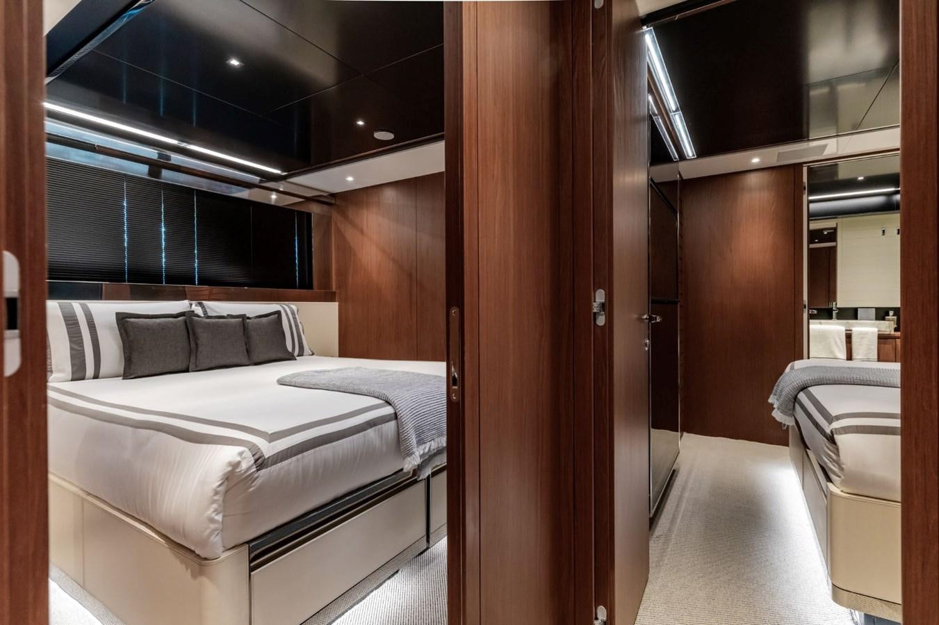 a room with a bed and a wood door aboard BEYOND BEYOND Yacht for Sale