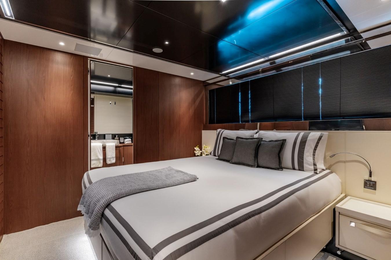 a room with a bed and a mirror aboard BEYOND BEYOND Yacht for Sale