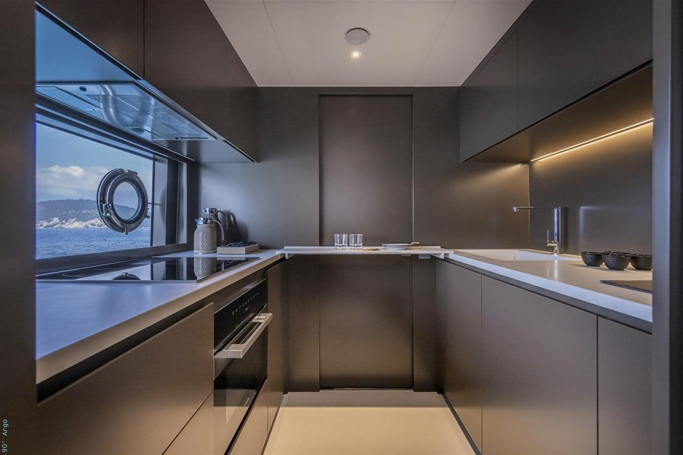 a kitchen with a large glass window aboard BEYOND BEYOND Yacht for Sale