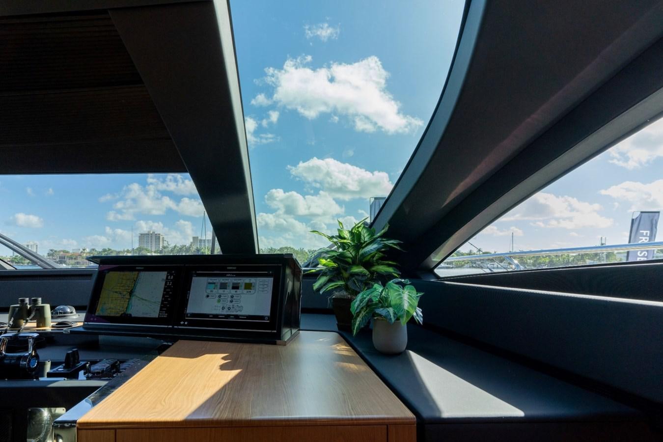 a desk with a laptop and a plant on it aboard BEYOND BEYOND Yacht for Sale