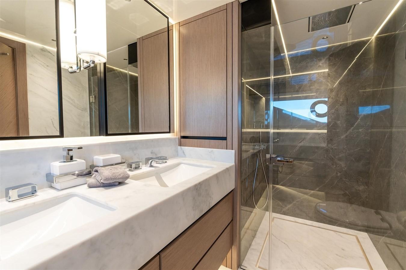 a bathroom with a glass shower aboard WORTH THE WAIT Yacht for Sale
