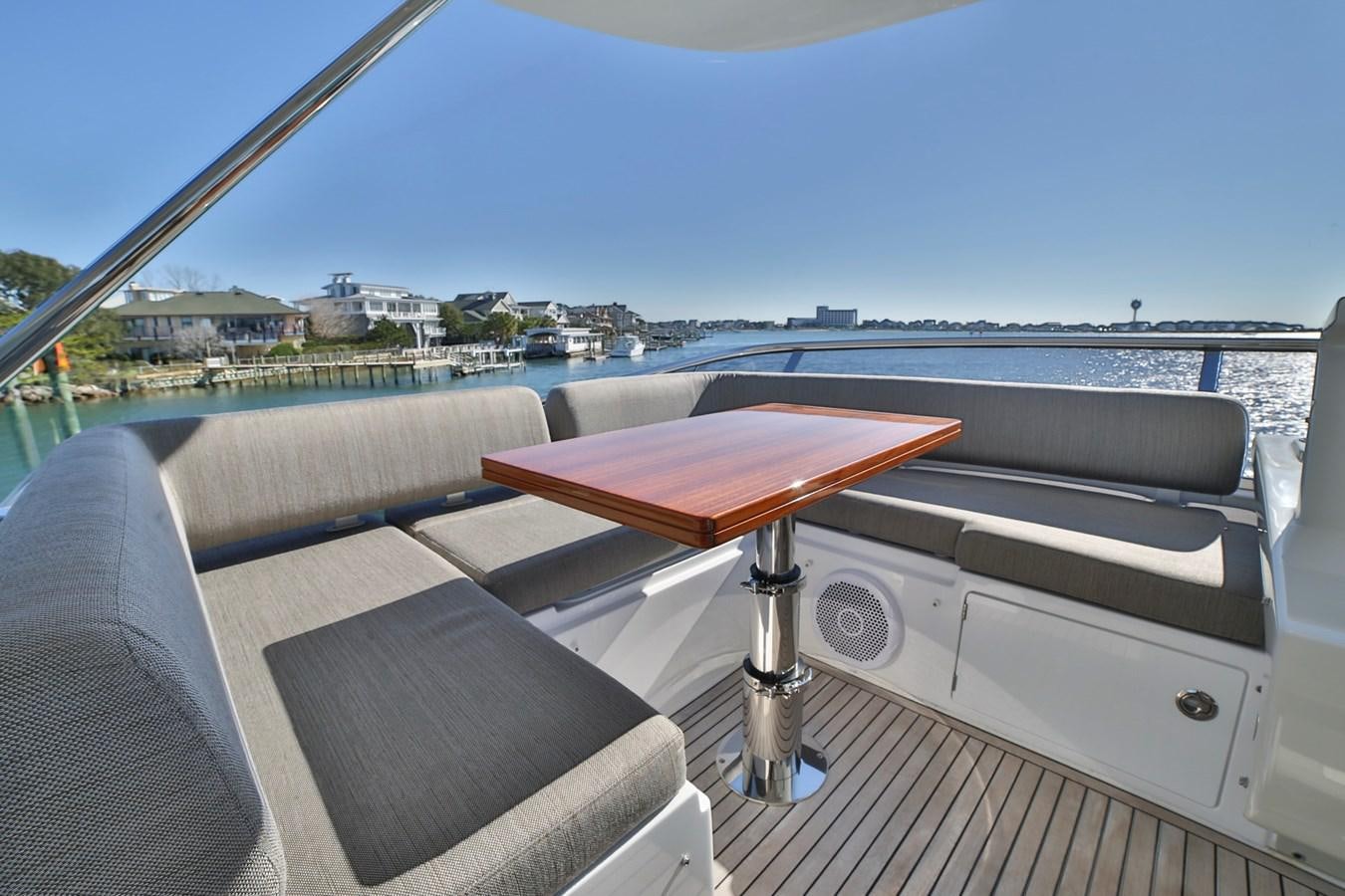 a deck with a table and chairs on it aboard SIRONA JOANNAH Yacht for Sale