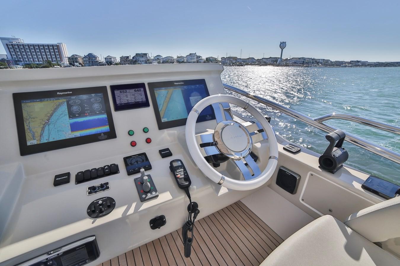 a boat with a steering wheel and a view of a city aboard SIRONA JOANNAH Yacht for Sale