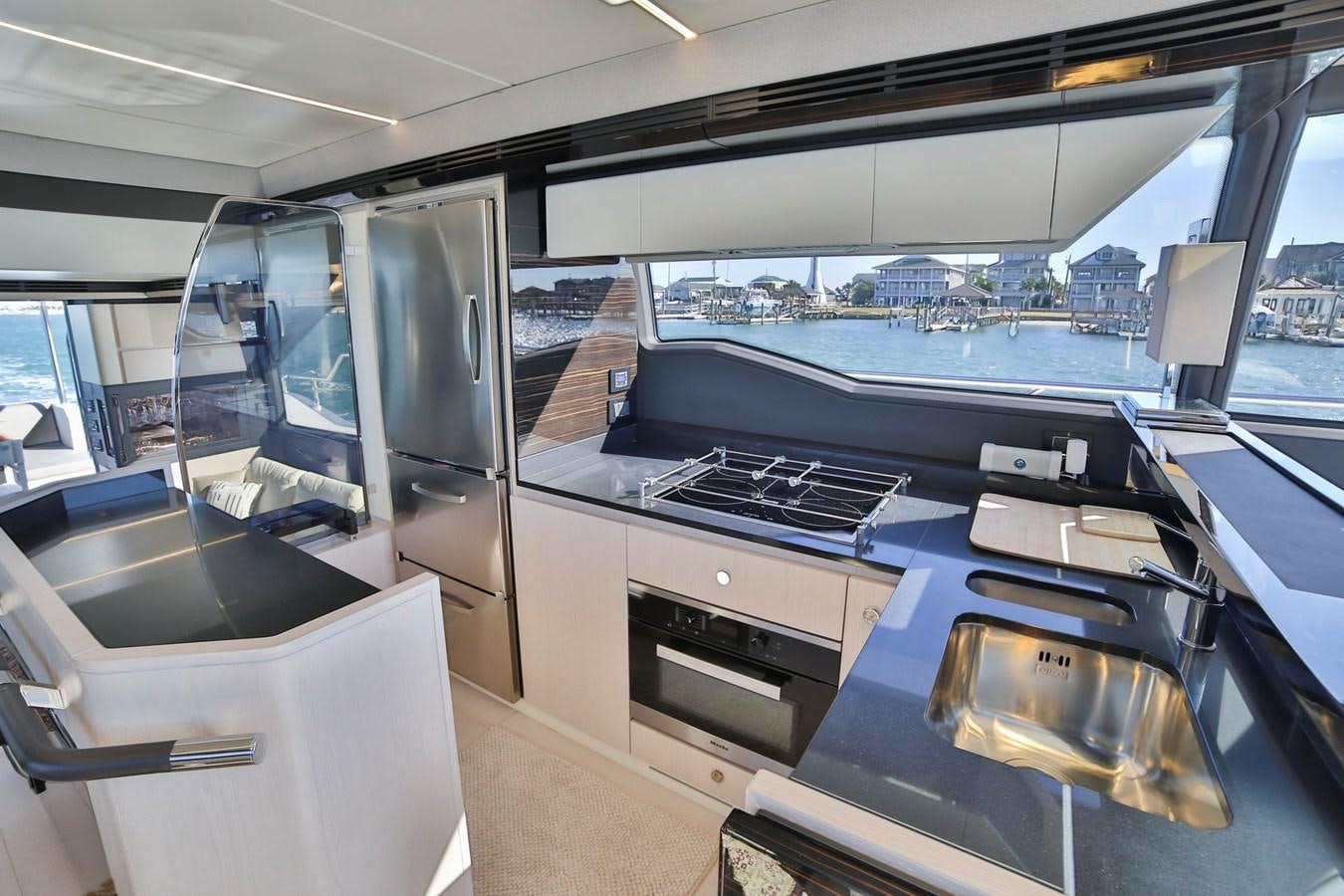 a kitchen with a large window aboard SIRONA JOANNAH Yacht for Sale