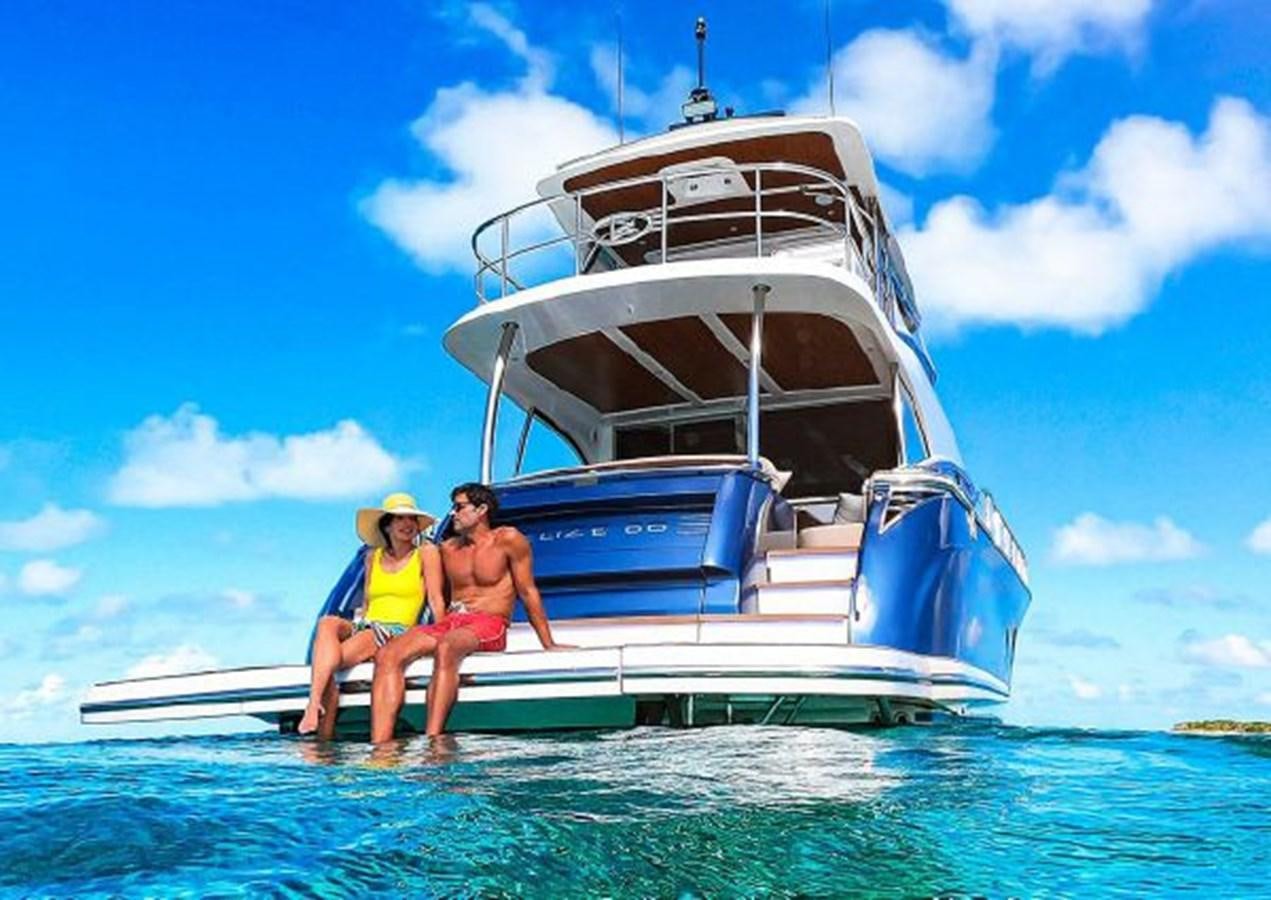 a group of people on a boat aboard 2023 RIVIERA 66 BELIZE DAYBRIDGE Yacht for Sale