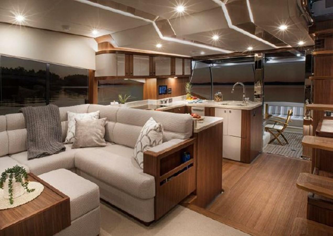 a living room with a couch aboard 2023 RIVIERA 66 BELIZE DAYBRIDGE Yacht for Sale