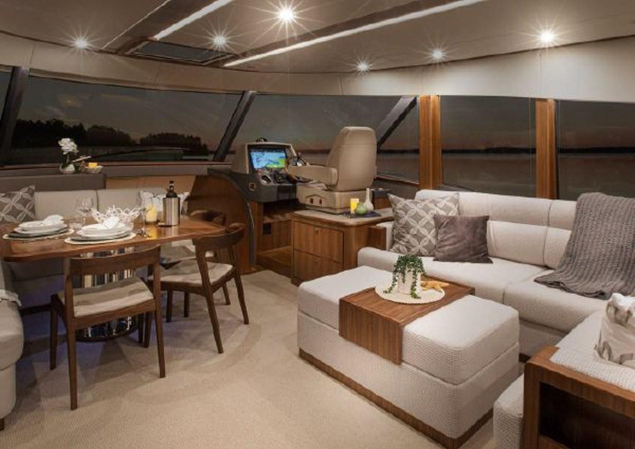 a living room with a couch and a table aboard 2023 RIVIERA 66 BELIZE DAYBRIDGE Yacht for Sale
