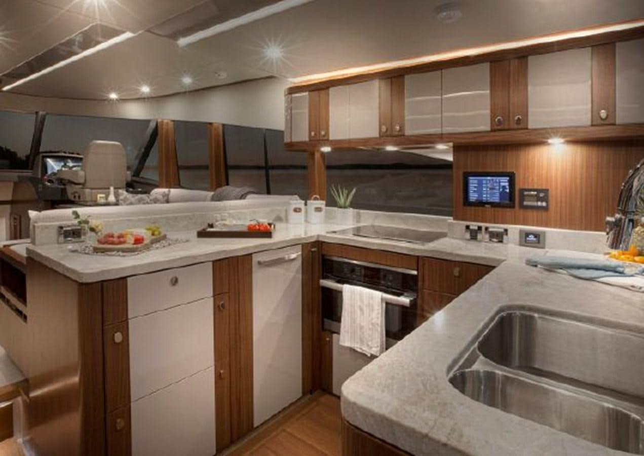 a kitchen with a large island aboard 2023 RIVIERA 66 BELIZE DAYBRIDGE Yacht for Sale