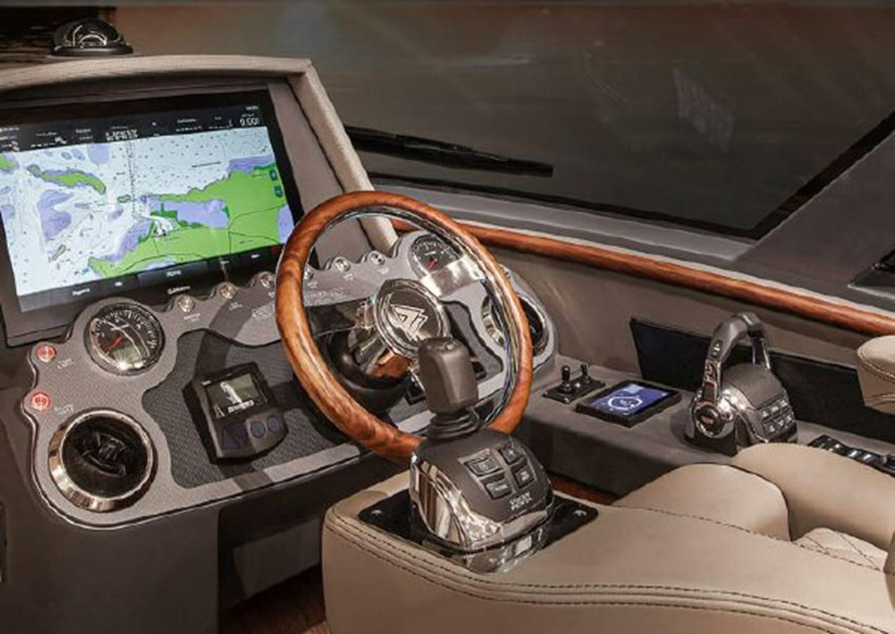 a car dashboard with a steering wheel aboard 2023 RIVIERA 66 BELIZE DAYBRIDGE Yacht for Sale