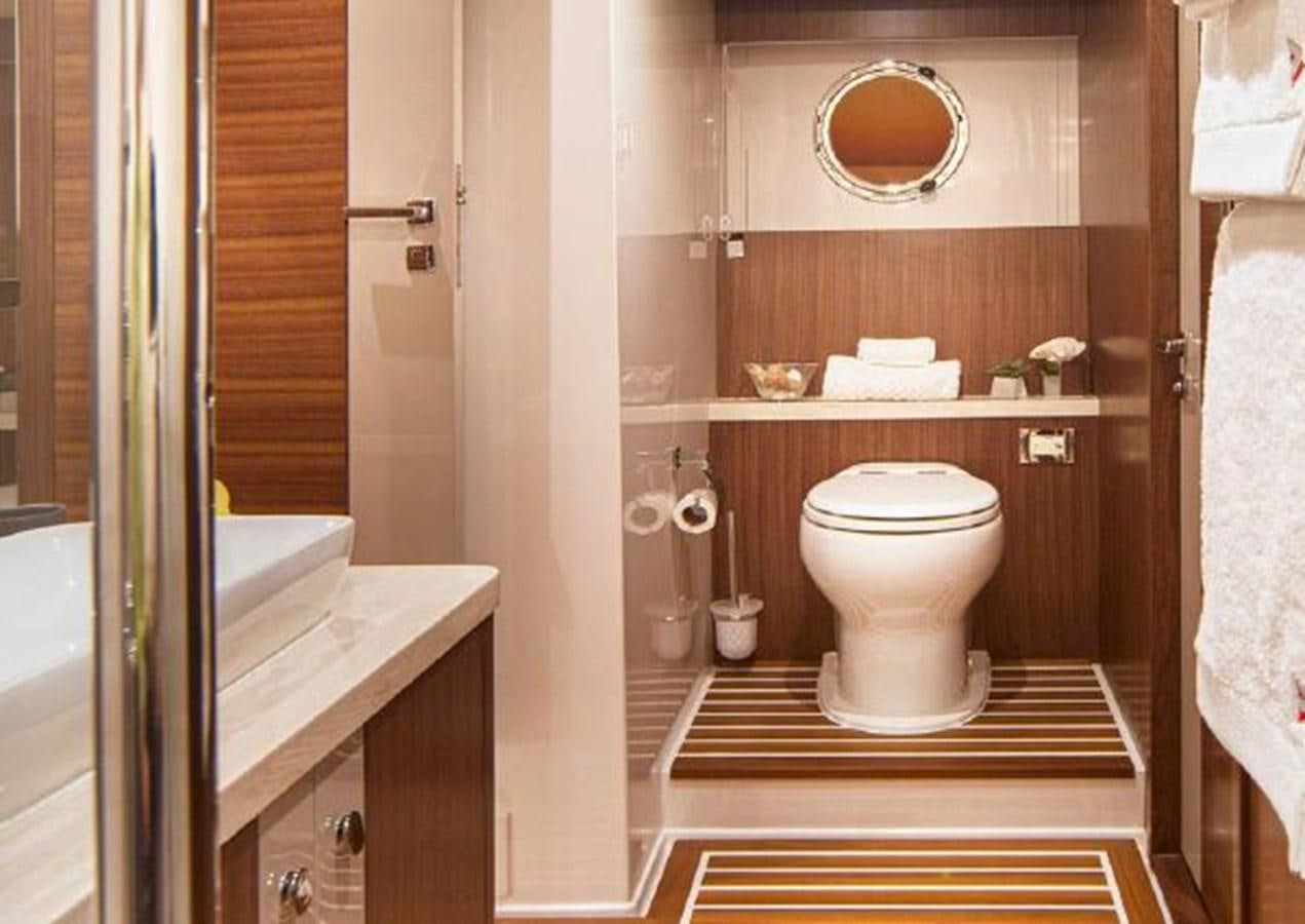a bathroom with a sink and toilet aboard 2023 RIVIERA 66 BELIZE DAYBRIDGE Yacht for Sale