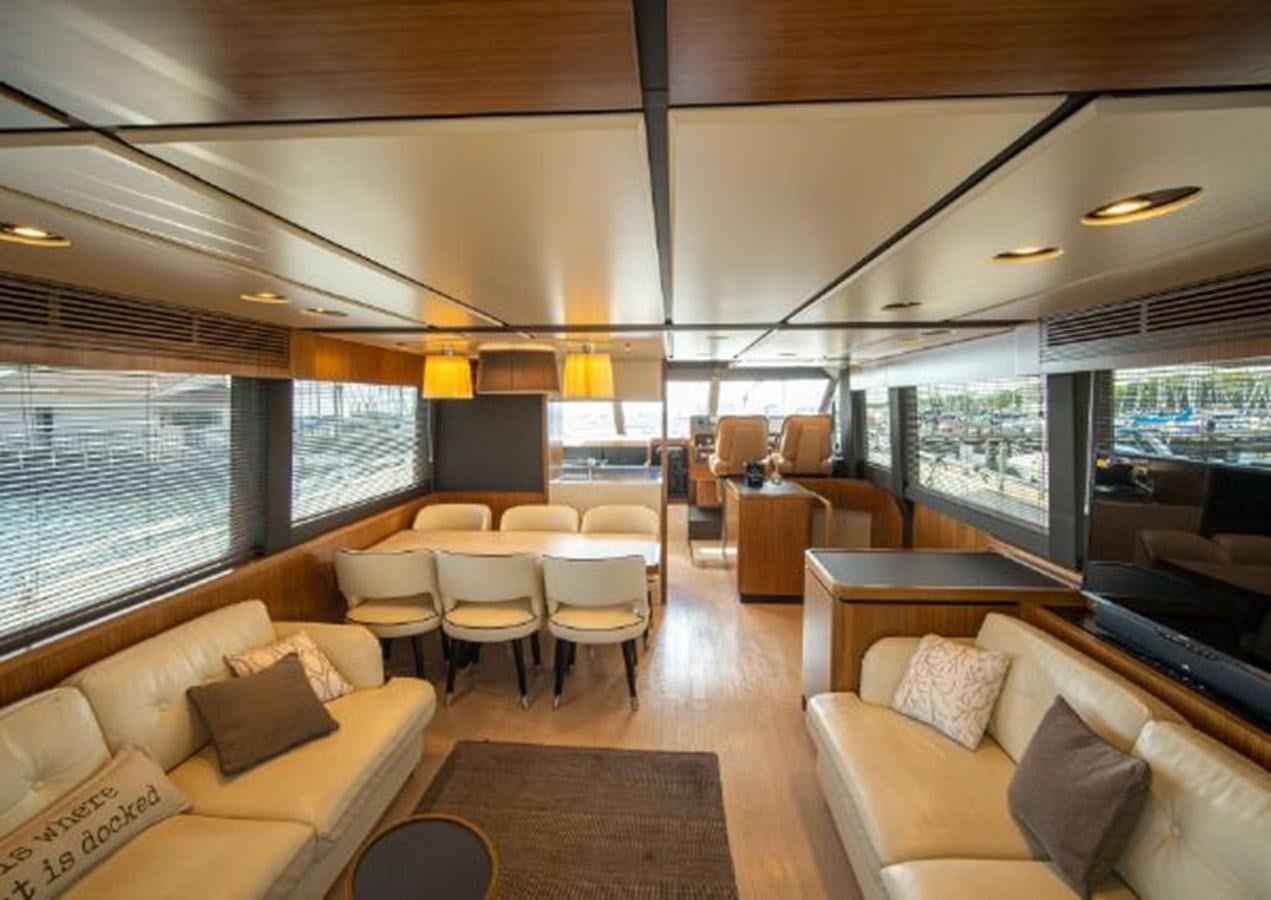 a living room with a large window aboard 2016 AZIMUT MAGELLANO 66 Yacht for Sale