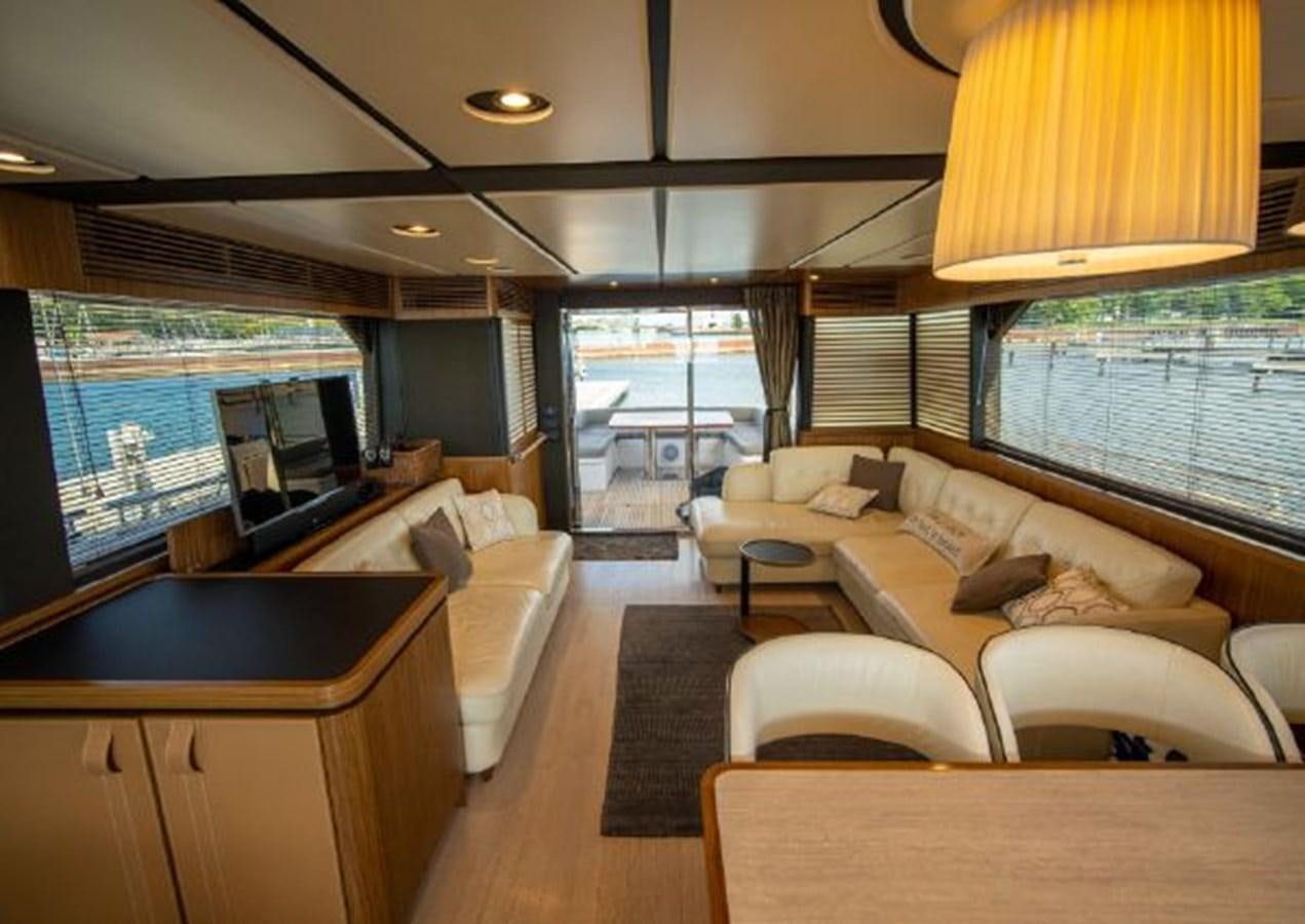 a living room with a large window aboard 2016 AZIMUT MAGELLANO 66 Yacht for Sale