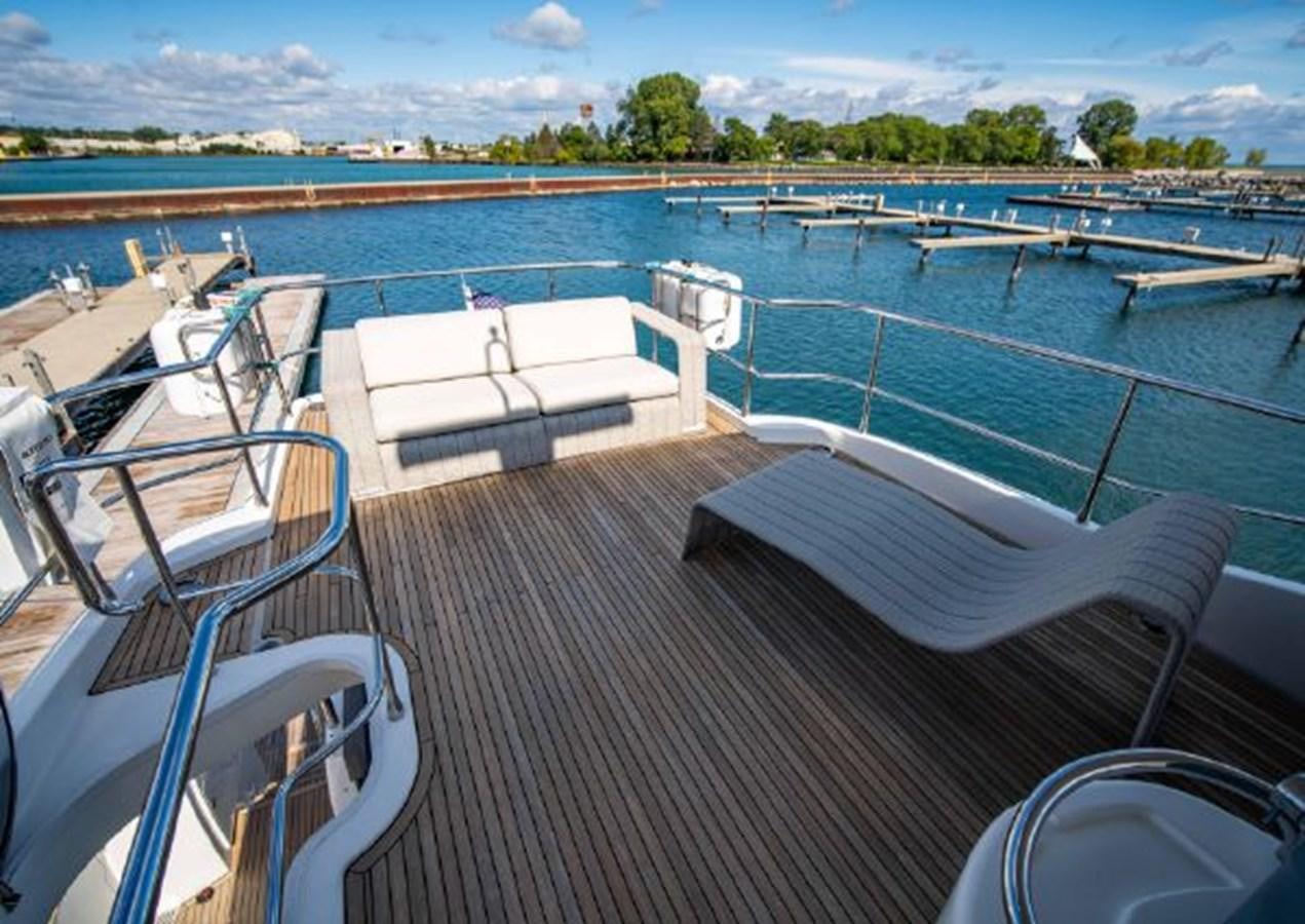 a deck with chairs and tables on it aboard 2016 AZIMUT MAGELLANO 66 Yacht for Sale