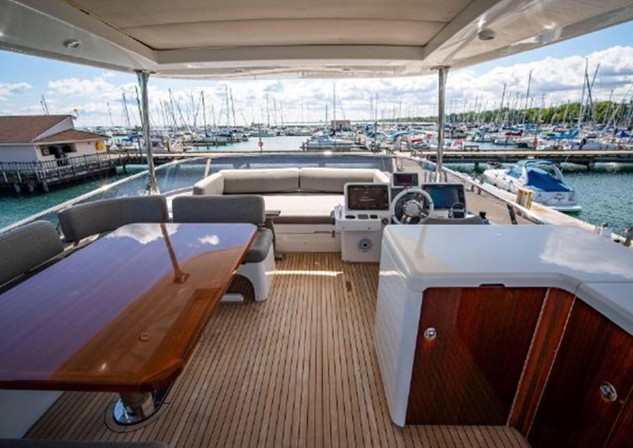 a deck with a deck and a deck with a view of the water aboard 2016 AZIMUT MAGELLANO 66 Yacht for Sale