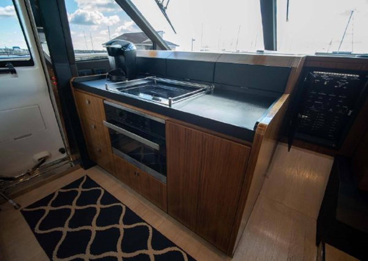 a kitchen with a stove and oven aboard 2016 AZIMUT MAGELLANO 66 Yacht for Sale