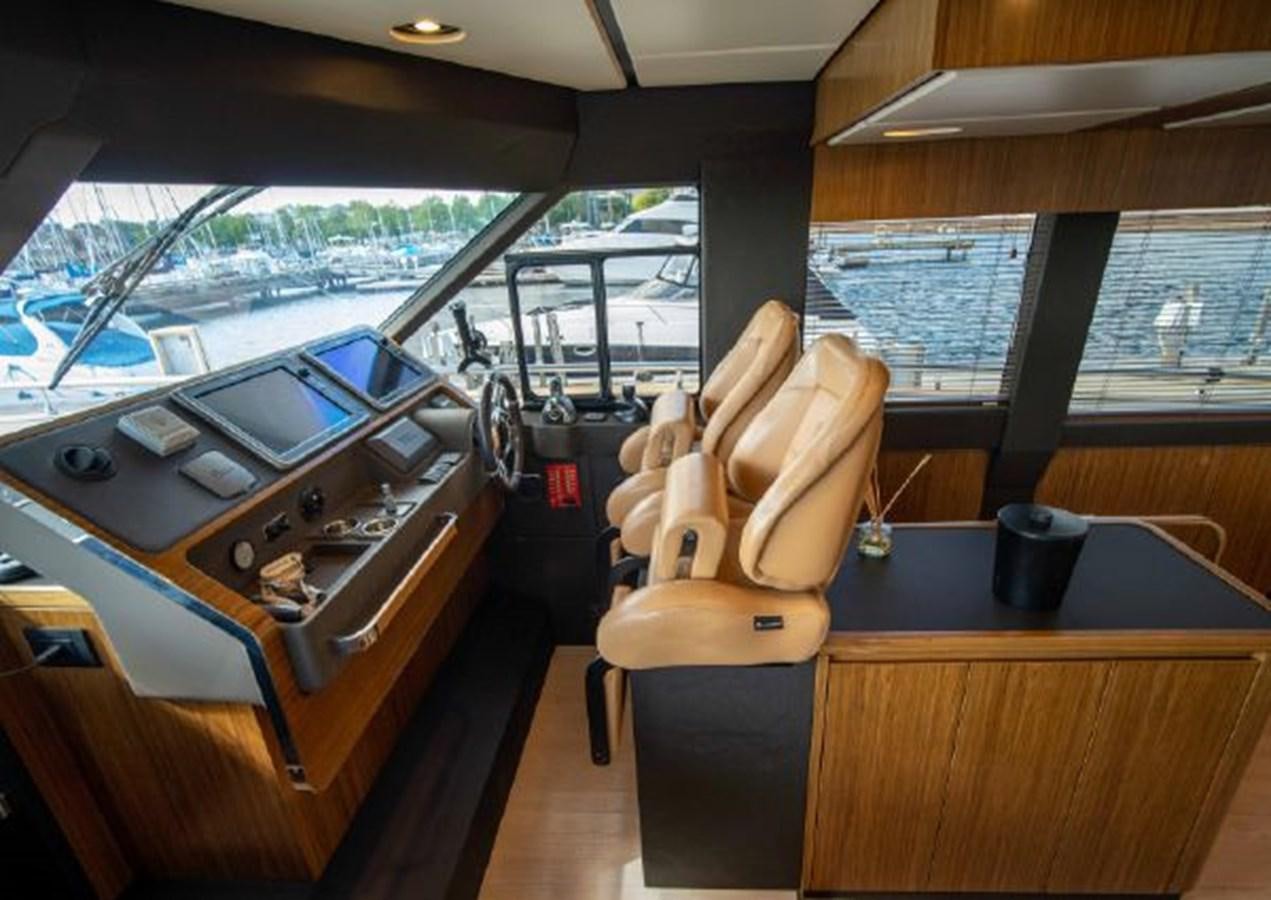 a room with a chair and a table and a stove aboard 2016 AZIMUT MAGELLANO 66 Yacht for Sale