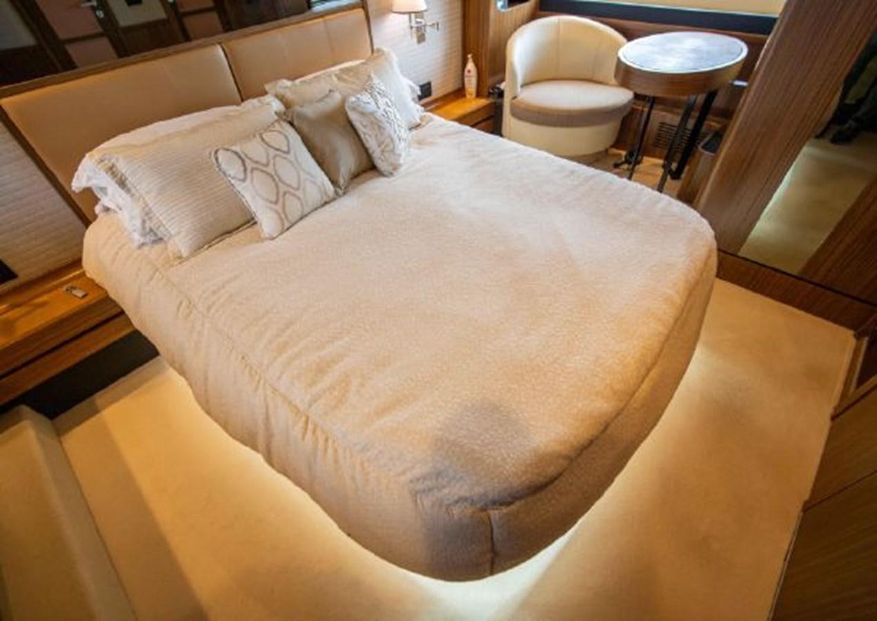 a bed with a white comforter aboard 2016 AZIMUT MAGELLANO 66 Yacht for Sale
