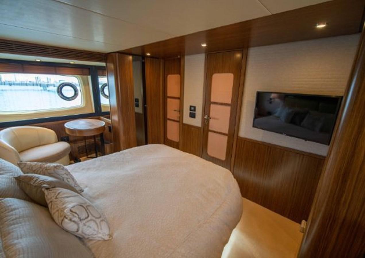a bedroom with a bed and a television aboard 2016 AZIMUT MAGELLANO 66 Yacht for Sale