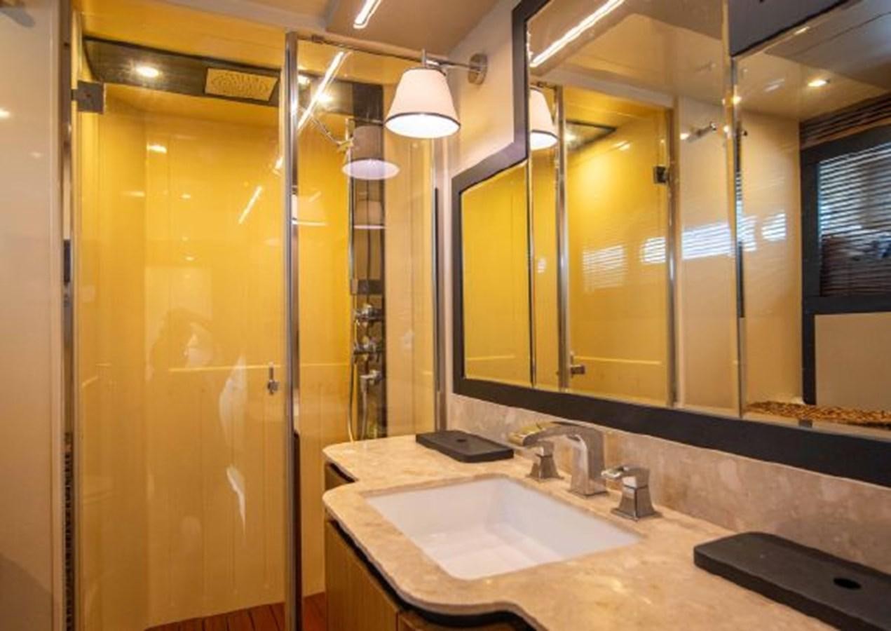 a bathroom with a countertop sink and mirrors aboard 2016 AZIMUT MAGELLANO 66 Yacht for Sale