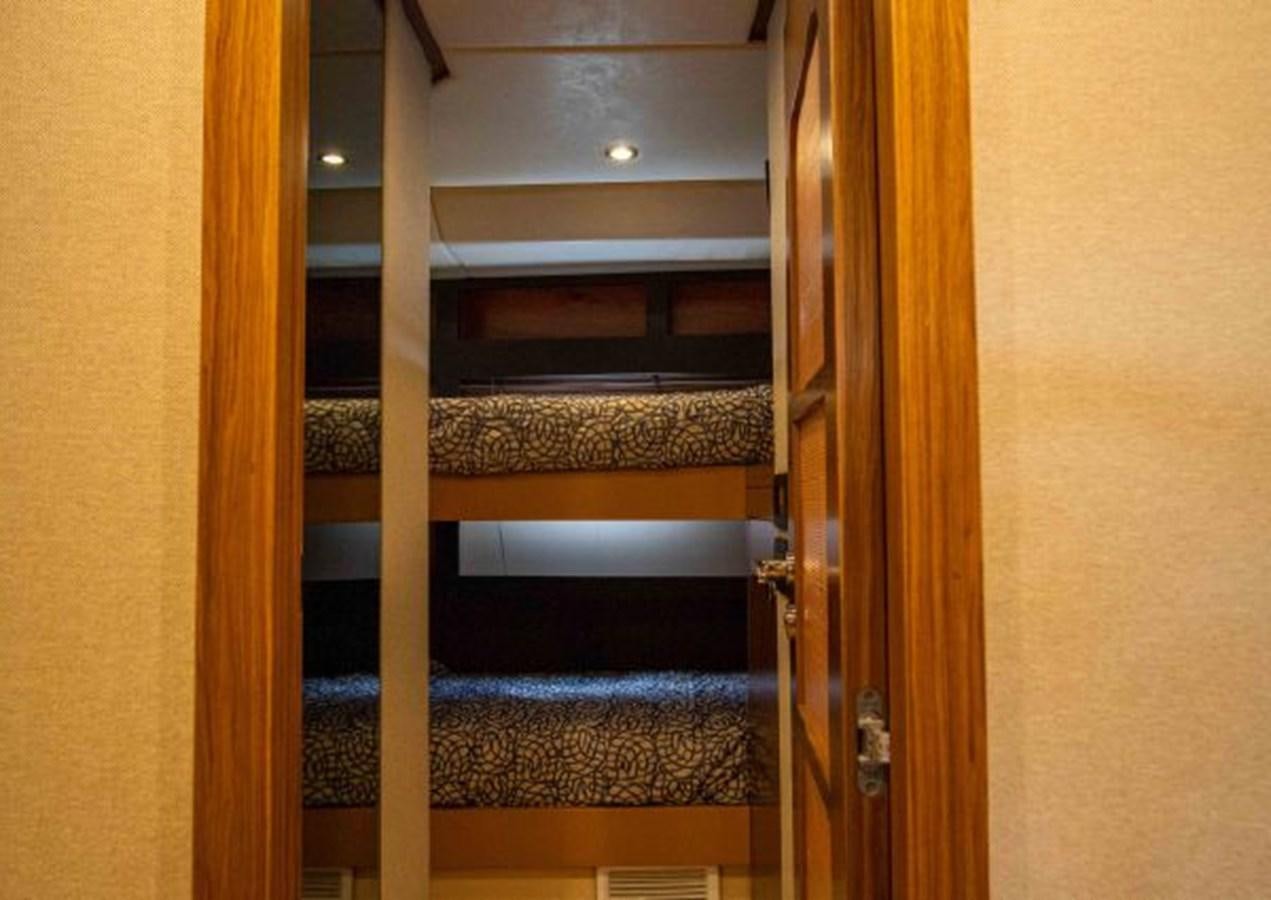 a wood bunk bed with a wood frame aboard 2016 AZIMUT MAGELLANO 66 Yacht for Sale